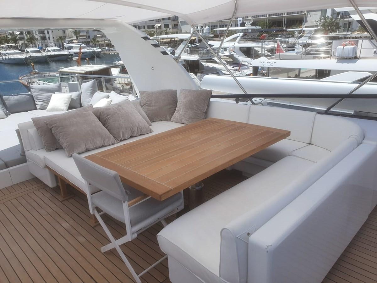 a table and chairs on a deck aboard P Yacht for Sale