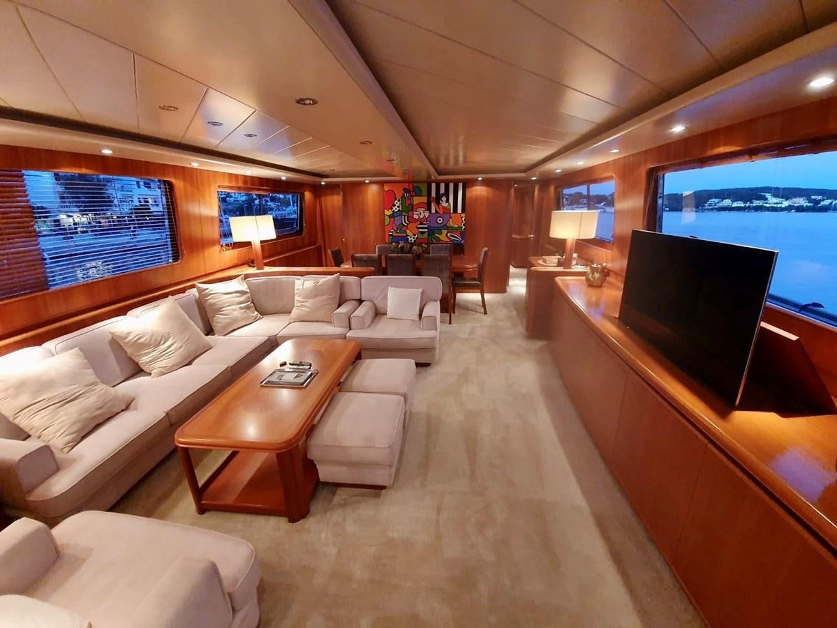 a living room with a large screen aboard P Yacht for Sale