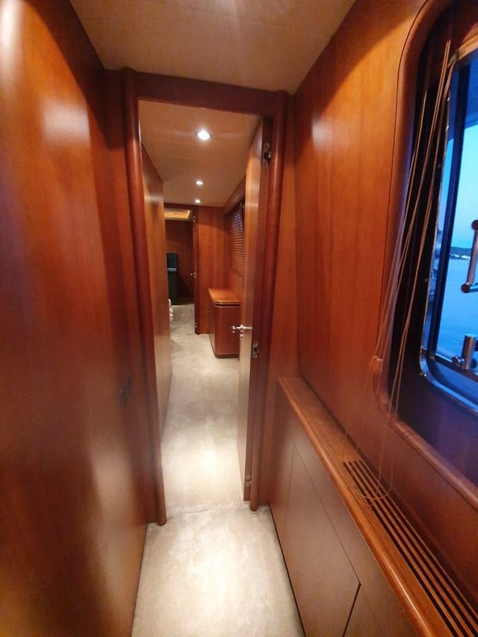 a hallway with a door and a window aboard P Yacht for Sale