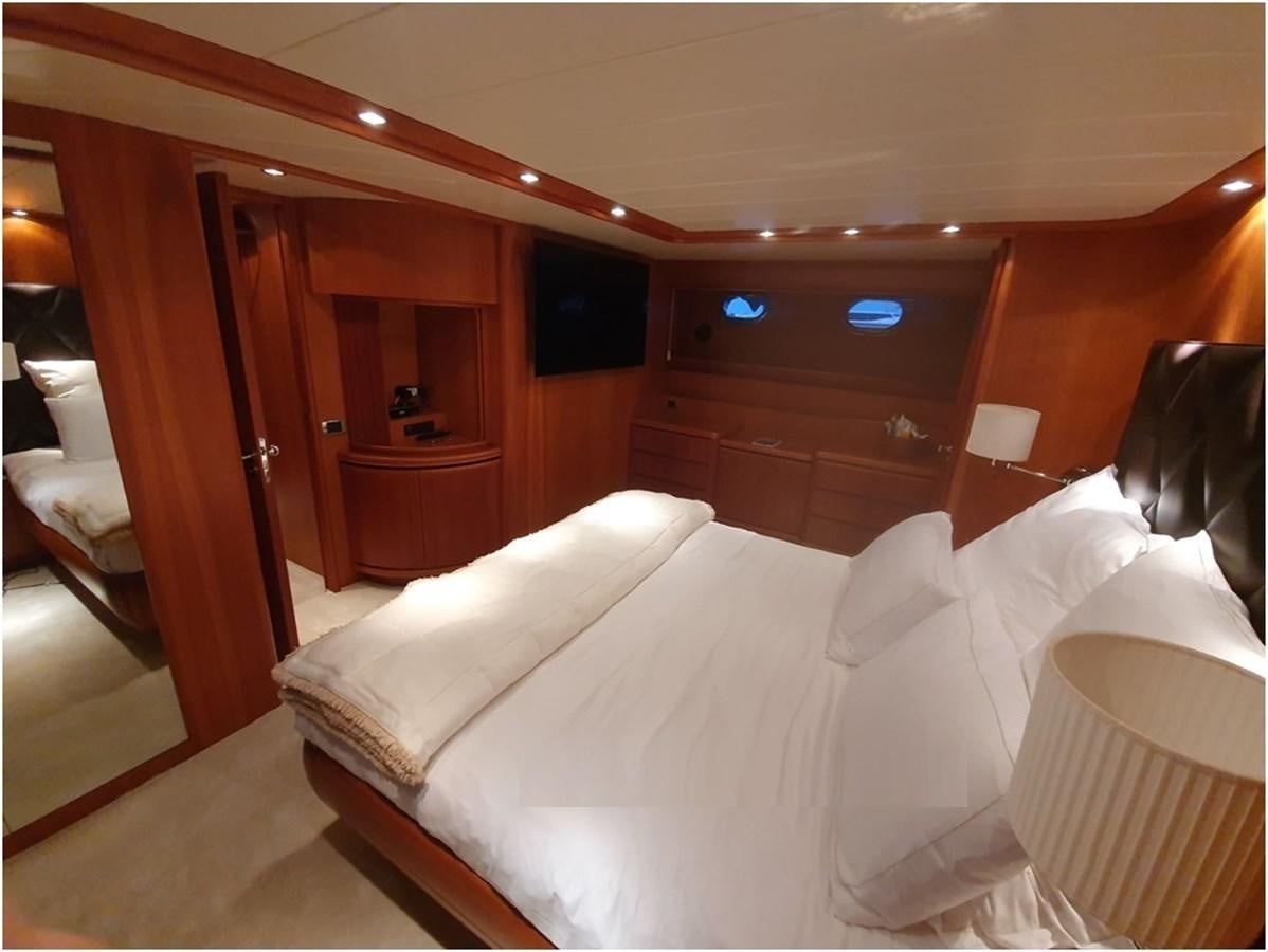 a bed with white sheets aboard P Yacht for Sale