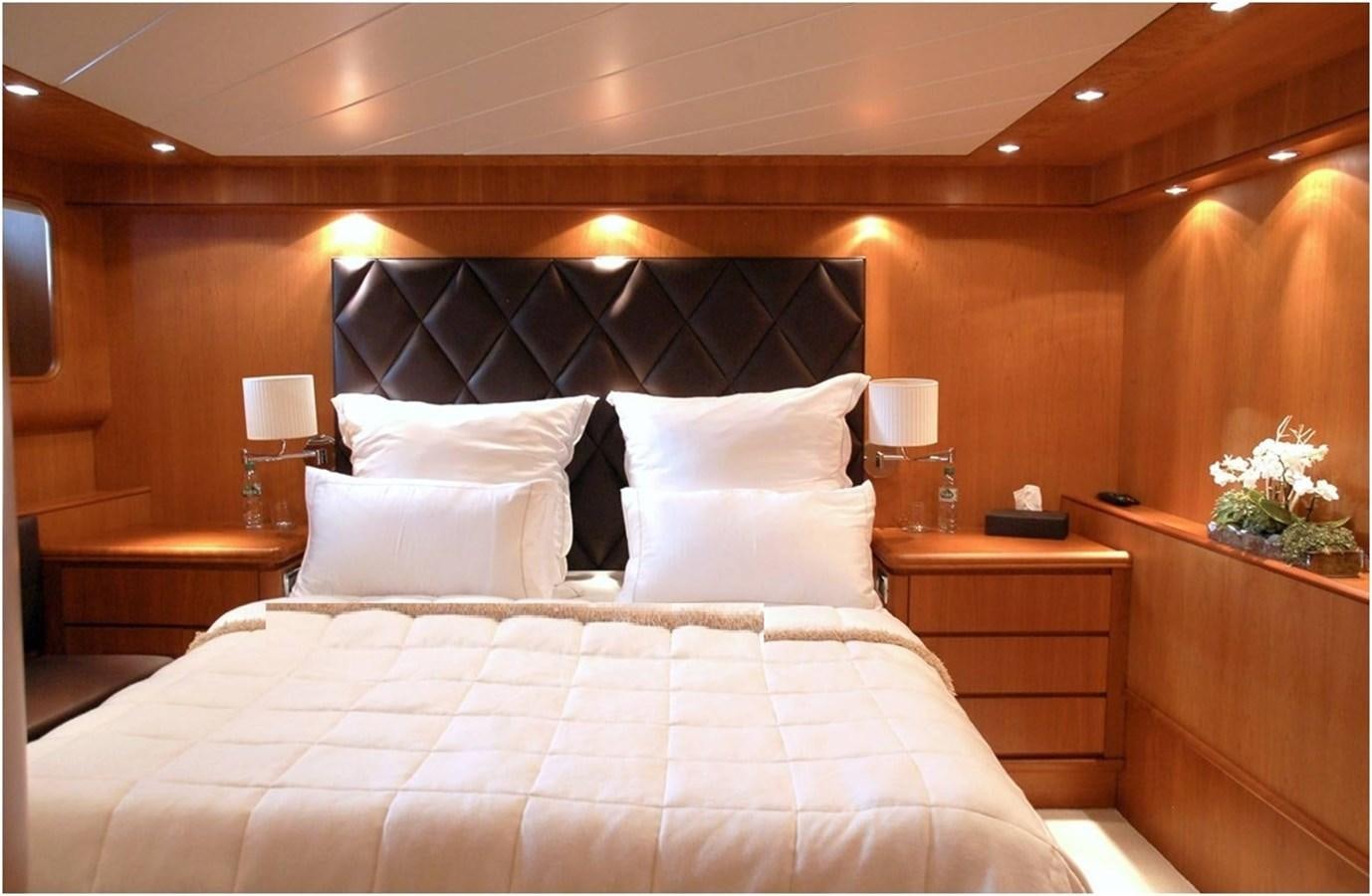 a bed with white pillows aboard P Yacht for Sale