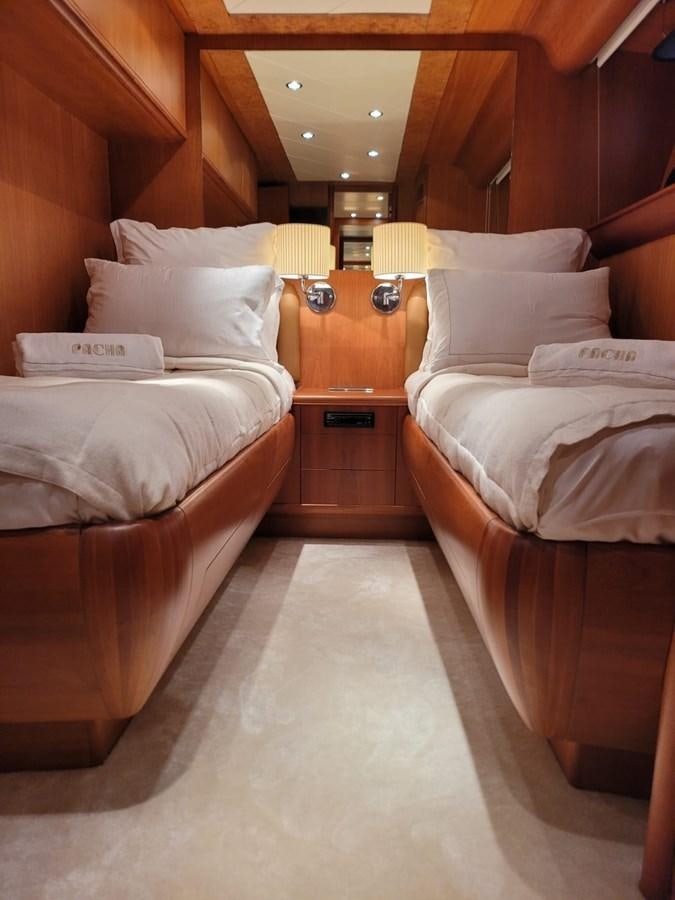 a room with beds and a lamp aboard P Yacht for Sale