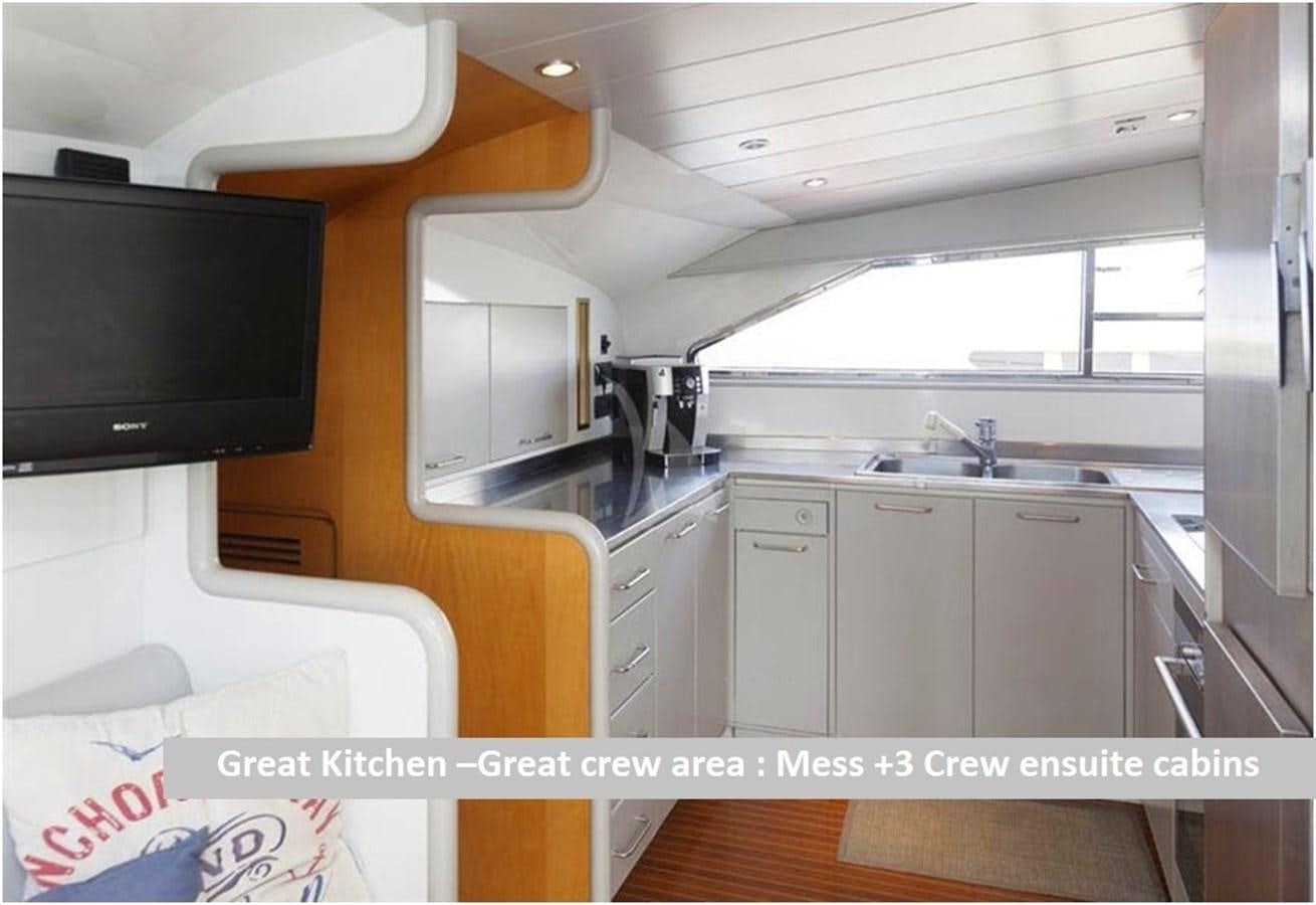 a kitchen with a tv and cabinets aboard P Yacht for Sale