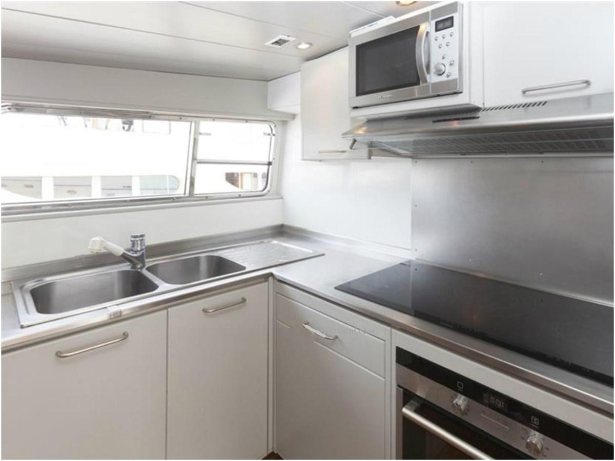 a kitchen with a microwave oven and a sink aboard P Yacht for Sale