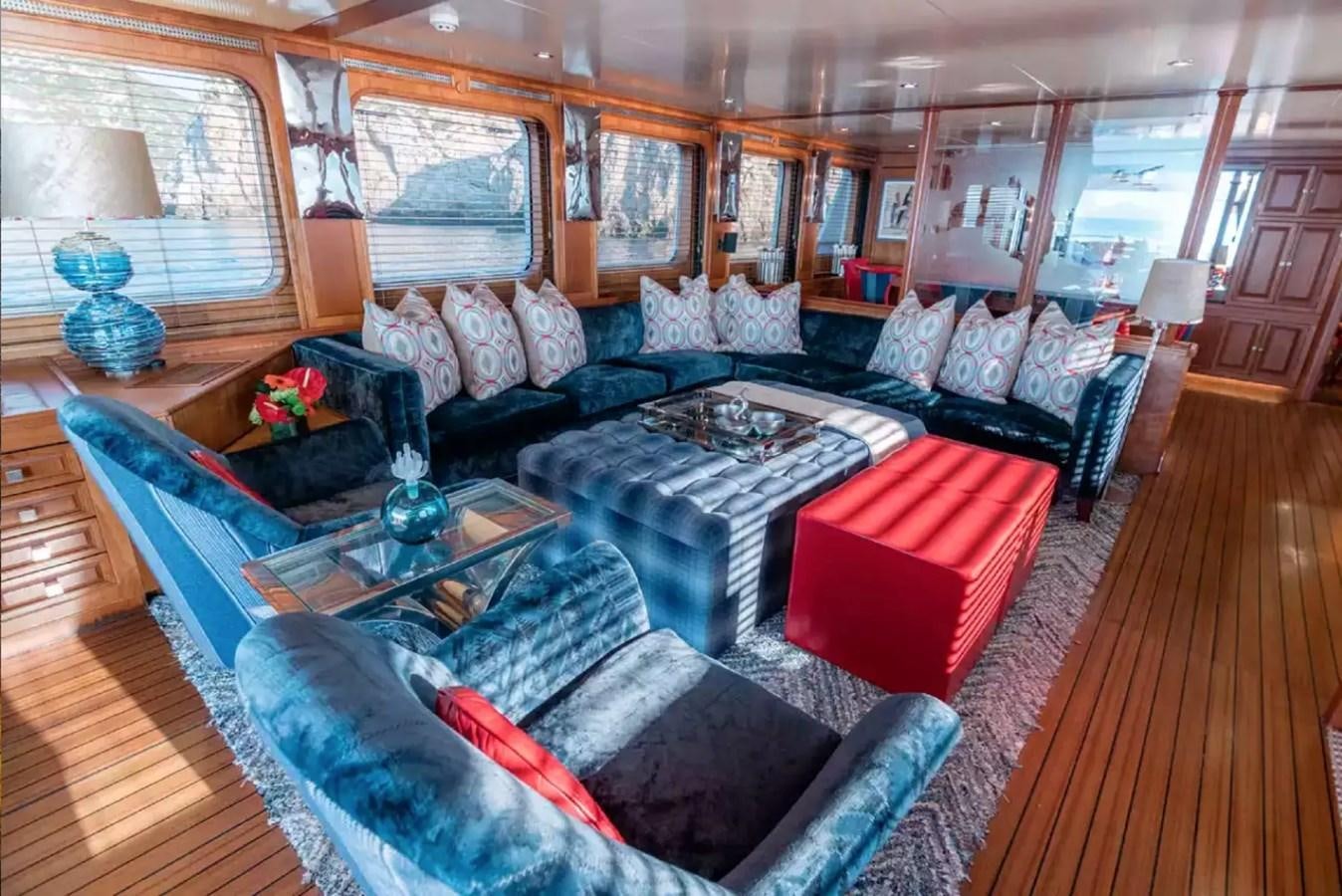 a living room with a large couch aboard CHARISMA Yacht for Sale