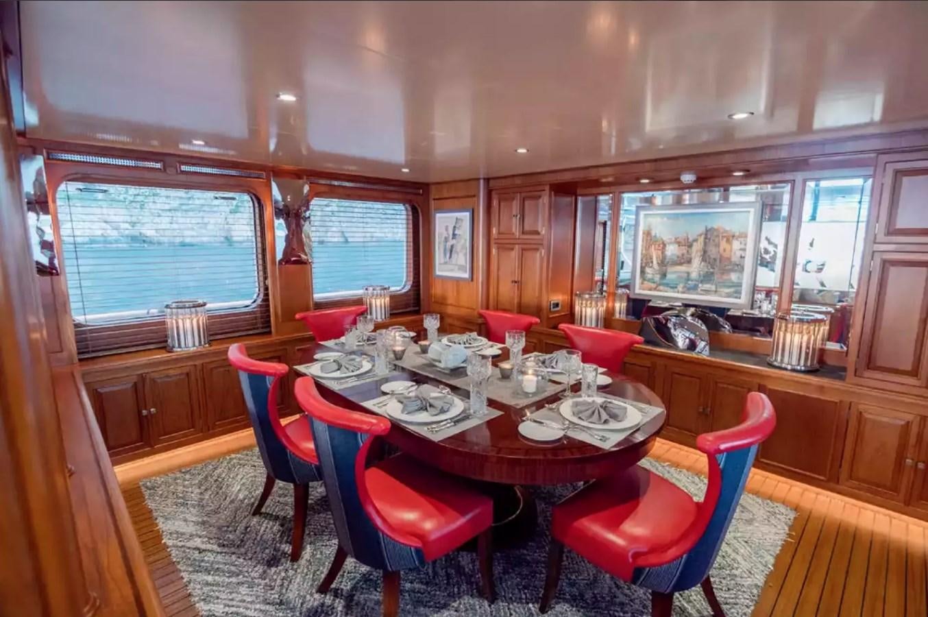 a dining room with a table and chairs aboard CHARISMA Yacht for Sale
