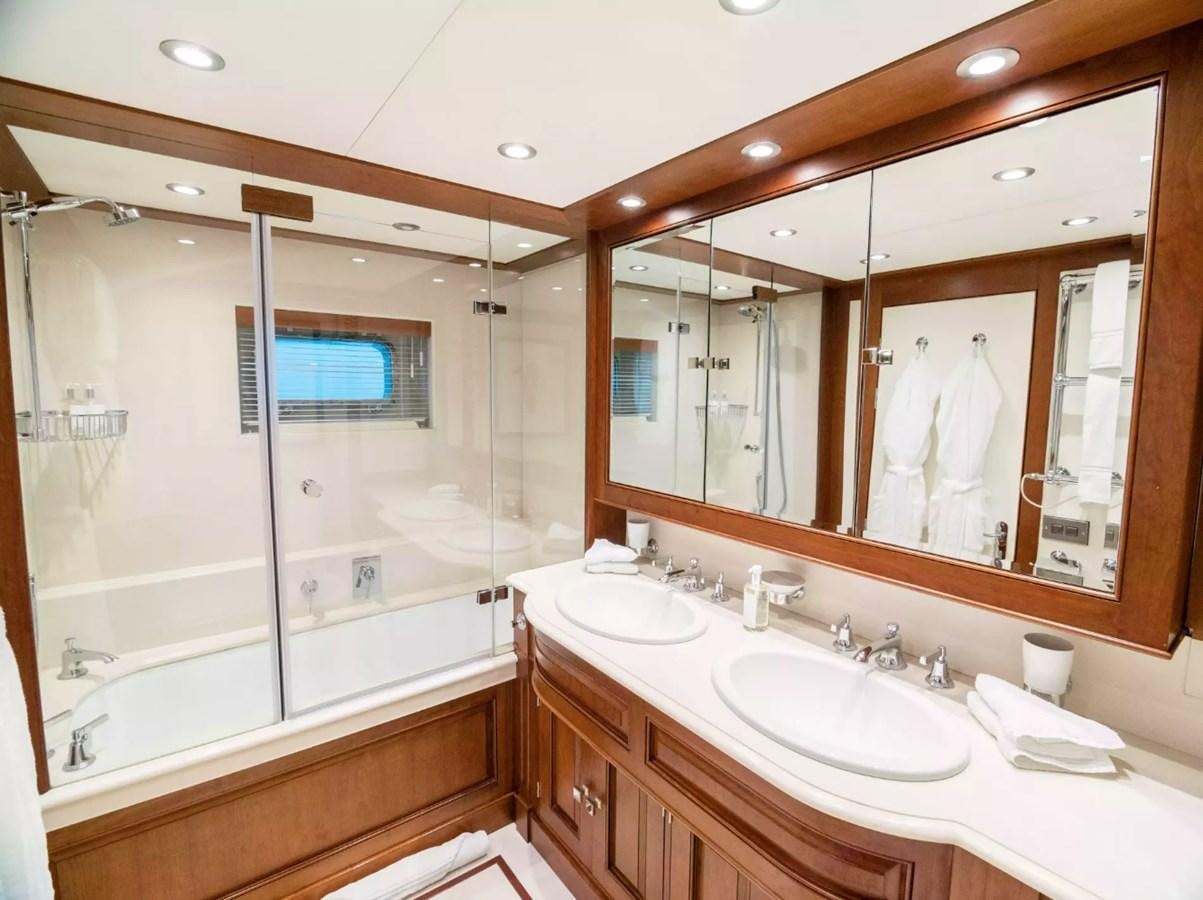 a bathroom with a large mirror aboard CHARISMA Yacht for Sale