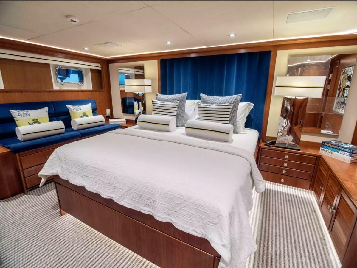 a bedroom with a bed and a blue and white bed aboard CHARISMA Yacht for Sale