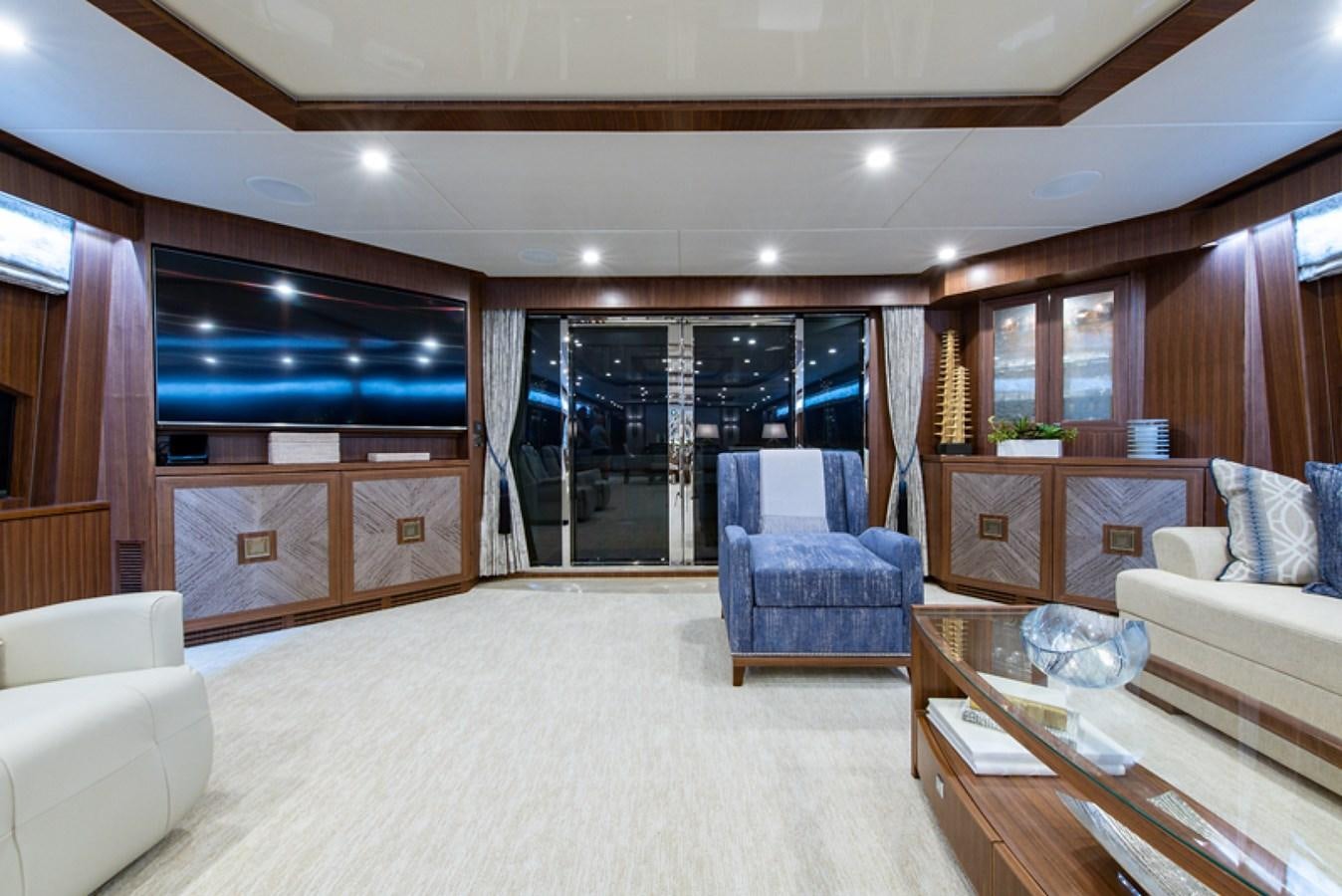 a living room with a large window aboard G120 SIGNATURE SERIES Yacht for Sale