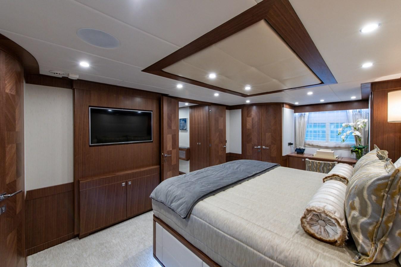 a bedroom with a bed and a television aboard G120 SIGNATURE SERIES Yacht for Sale