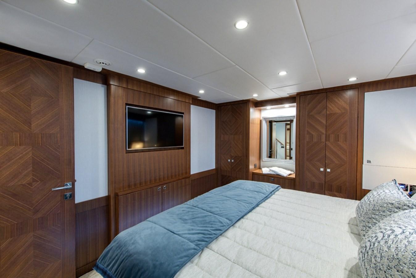 a bedroom with a bed and a television aboard G120 SIGNATURE SERIES Yacht for Sale