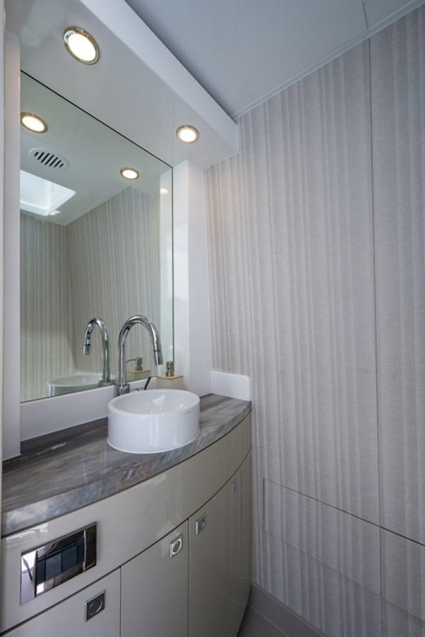 a bathroom with a sink and a mirror aboard G120 SIGNATURE SERIES Yacht for Sale