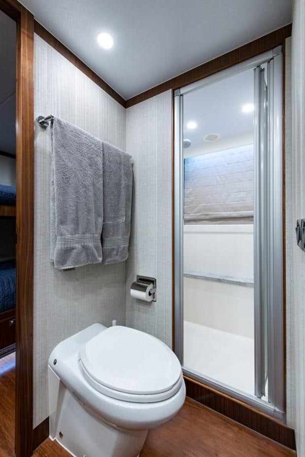 a bathroom with a toilet and towels aboard G120 SIGNATURE SERIES Yacht for Sale