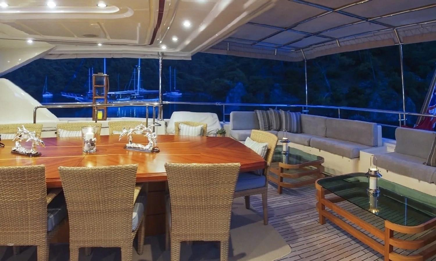 a large room with a table and chairs aboard ARIELA Yacht for Sale