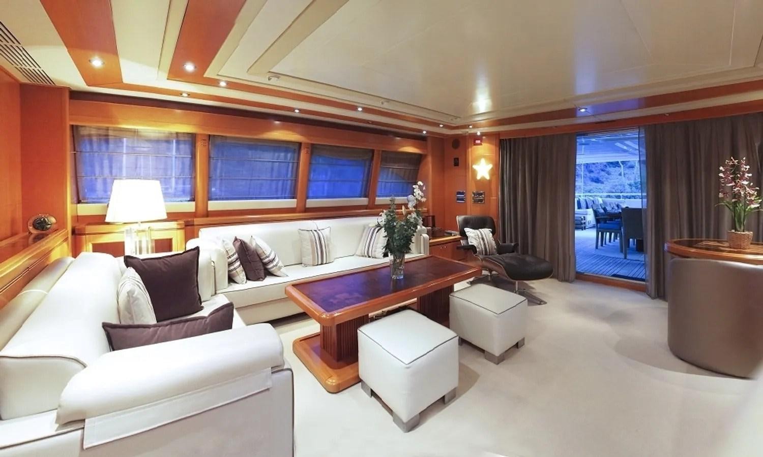 a living room with a couch and a coffee table aboard ARIELA Yacht for Sale