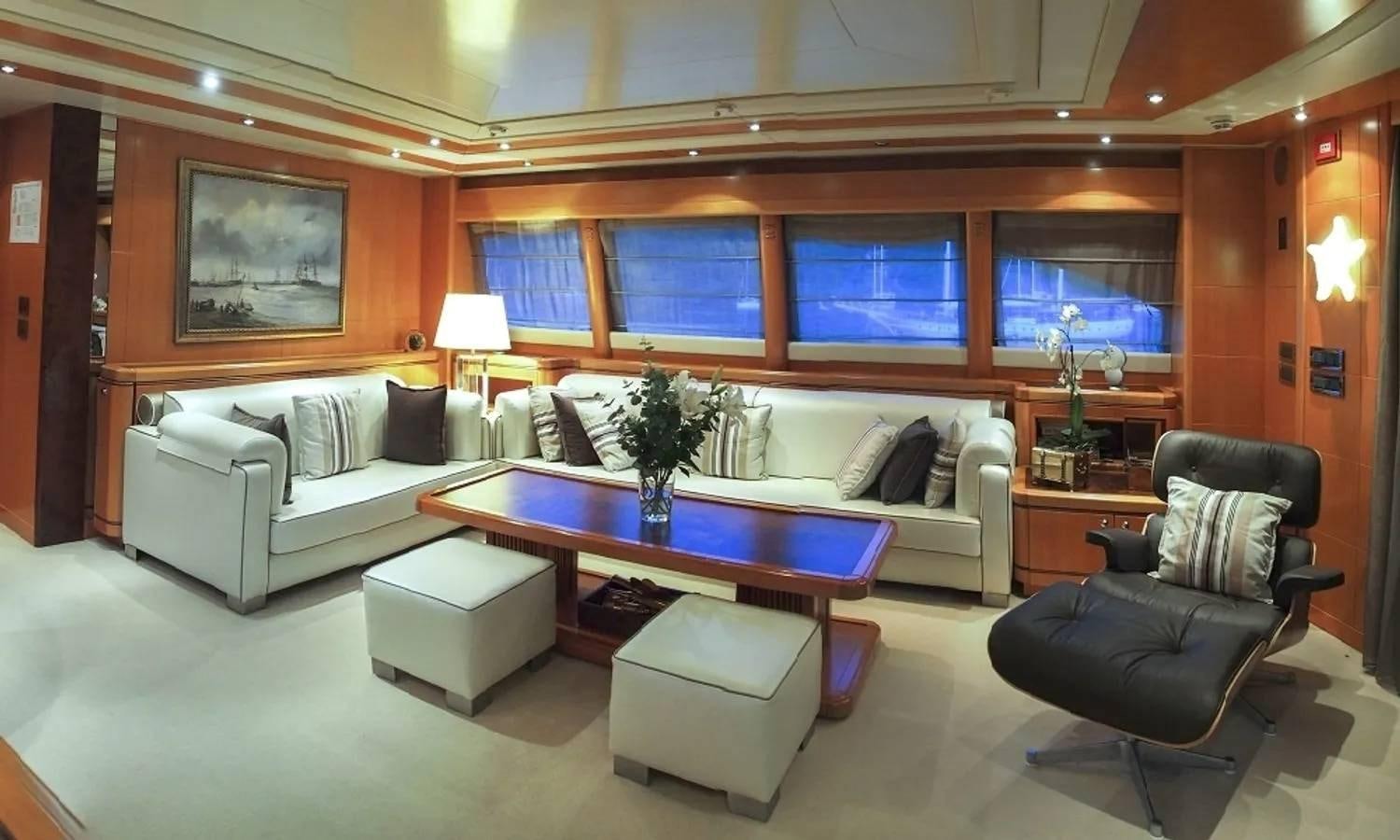 a living room with a table and chairs aboard ARIELA Yacht for Sale