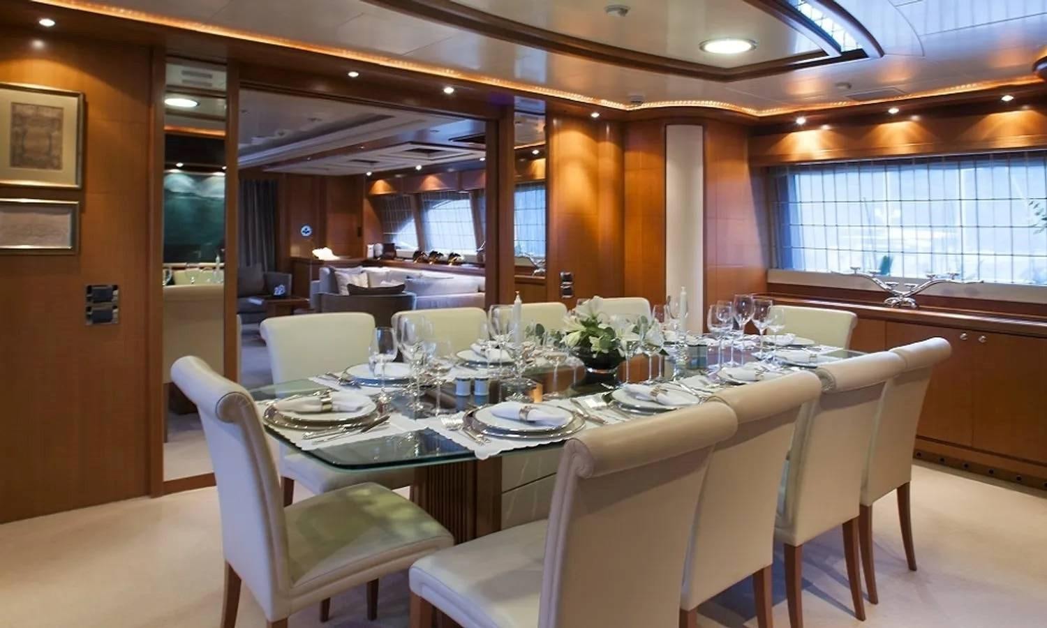 a dining room with a table and chairs aboard ARIELA Yacht for Sale