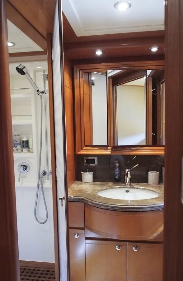 a bathroom with a sink and a mirror aboard ARIELA Yacht for Sale