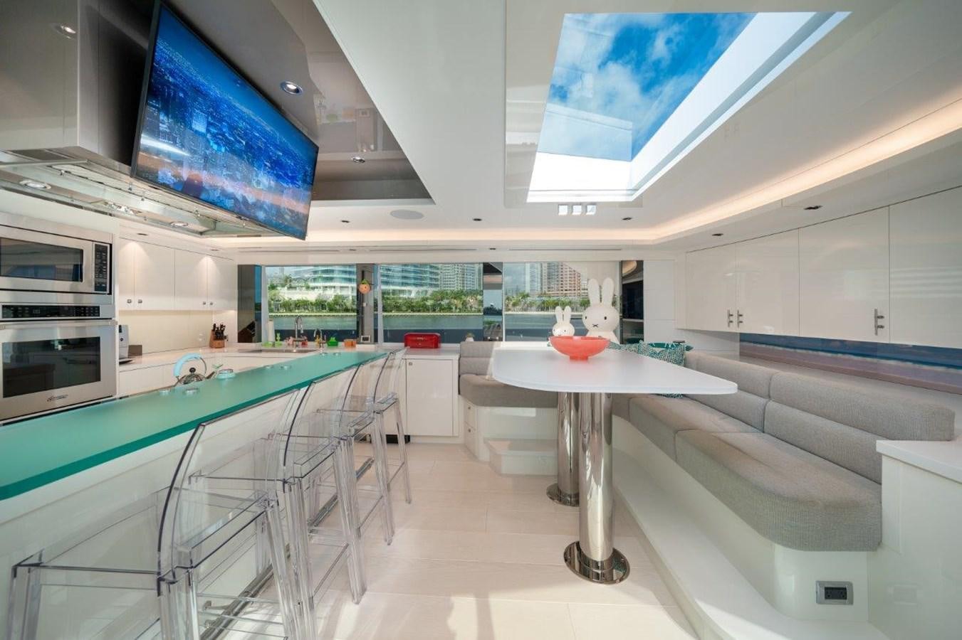 a room with a table and chairs aboard RING-N-WET Yacht for Sale
