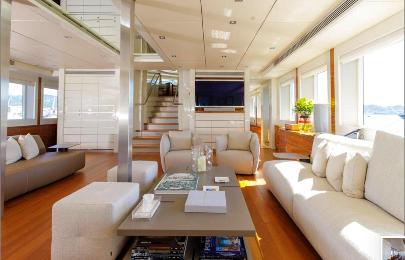 a living room with a table and couches aboard BASMALINA II Yacht for Sale