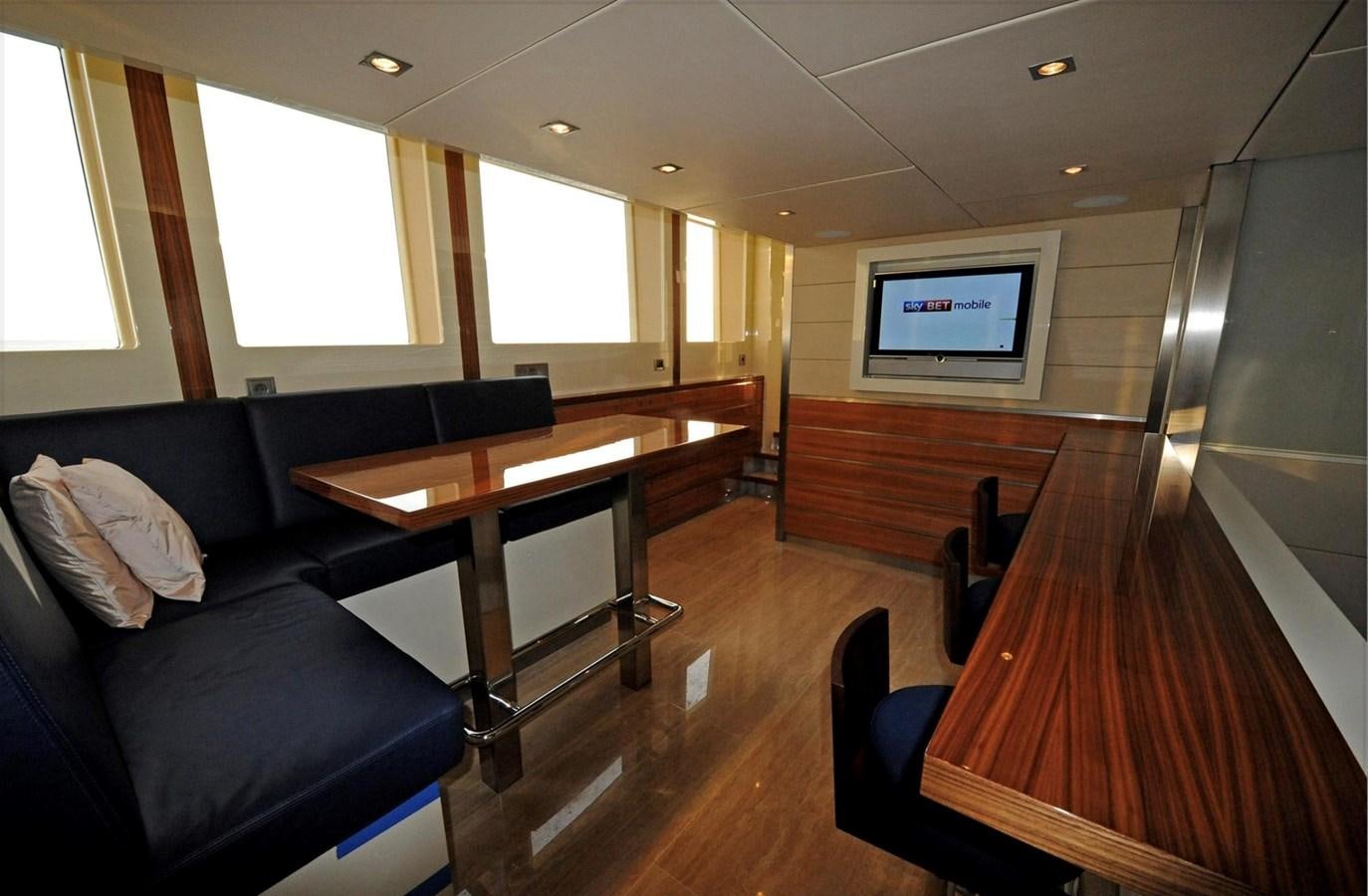 a room with a couch and a tv aboard BASMALINA II Yacht for Sale