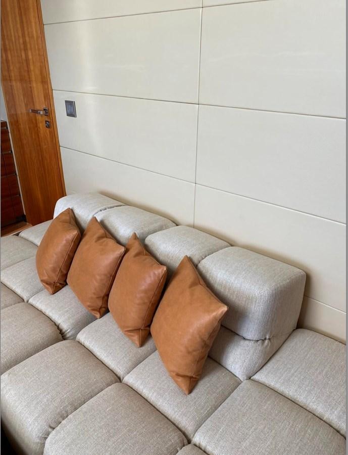 a couch with pillows aboard BASMALINA II Yacht for Sale