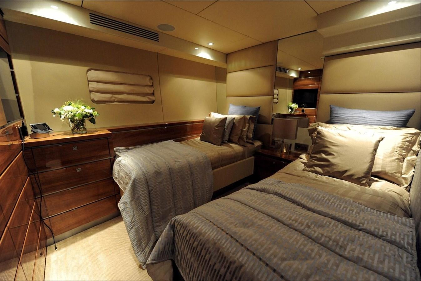 a bedroom with two beds aboard BASMALINA II Yacht for Sale