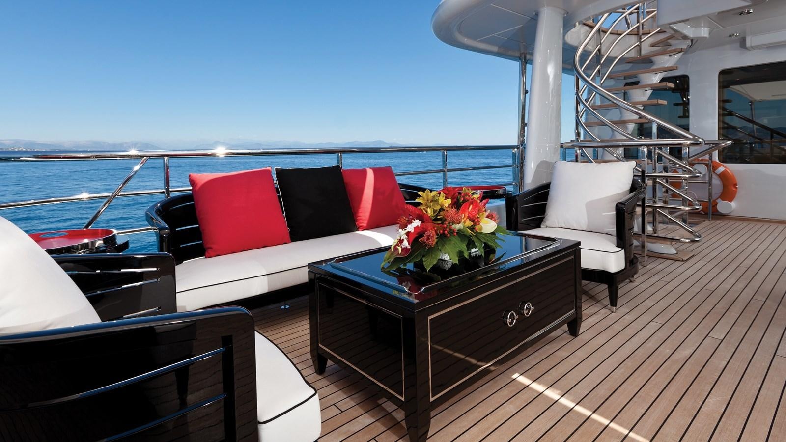 a balcony with a table and chairs aboard STEP ONE Yacht for Sale