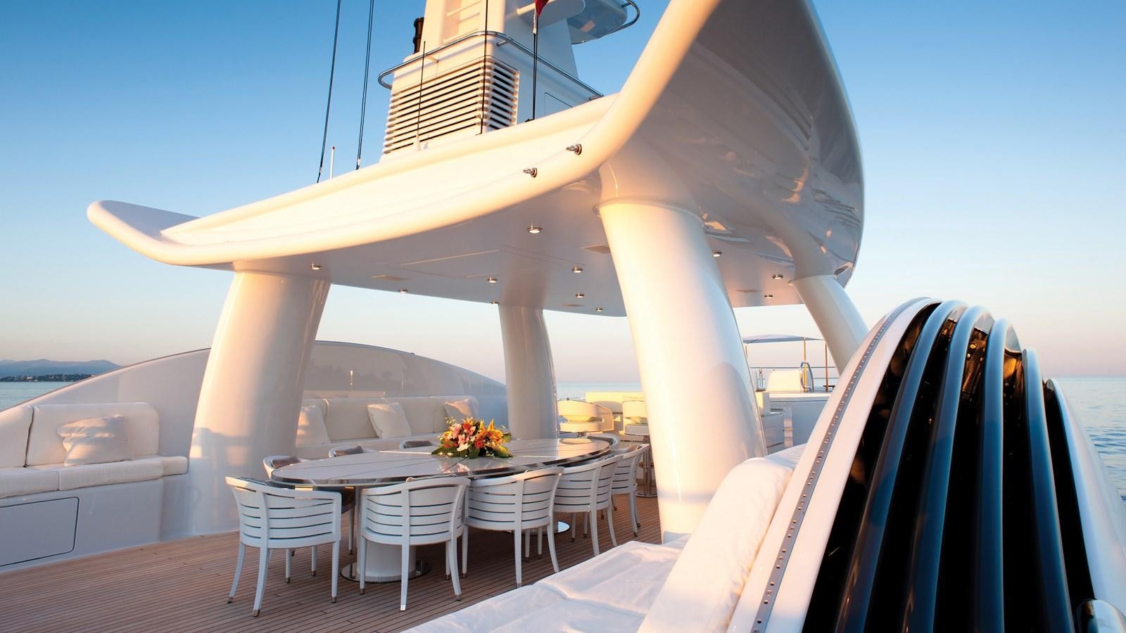 a large white building with a table and chairs and a large arch aboard STEP ONE Yacht for Sale
