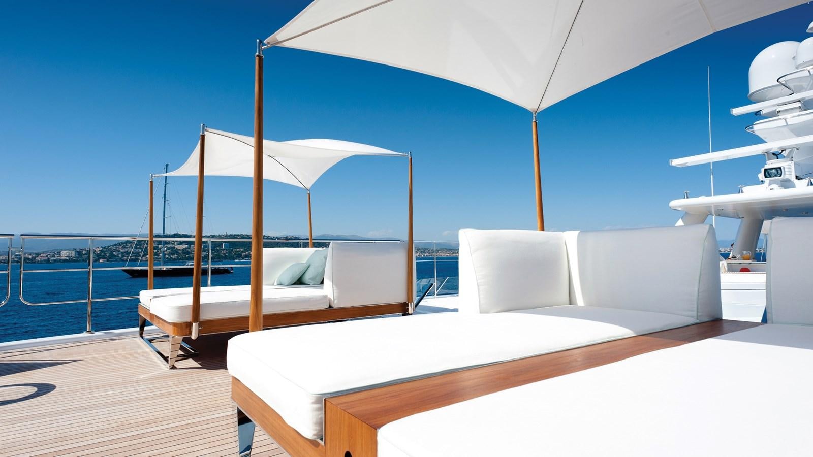 a bed and a couch in a room aboard STEP ONE Yacht for Sale