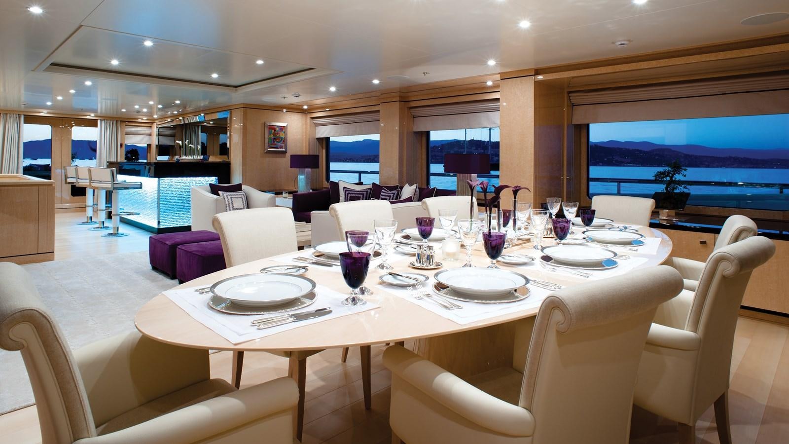 a large room with a table and chairs and a tv aboard STEP ONE Yacht for Sale