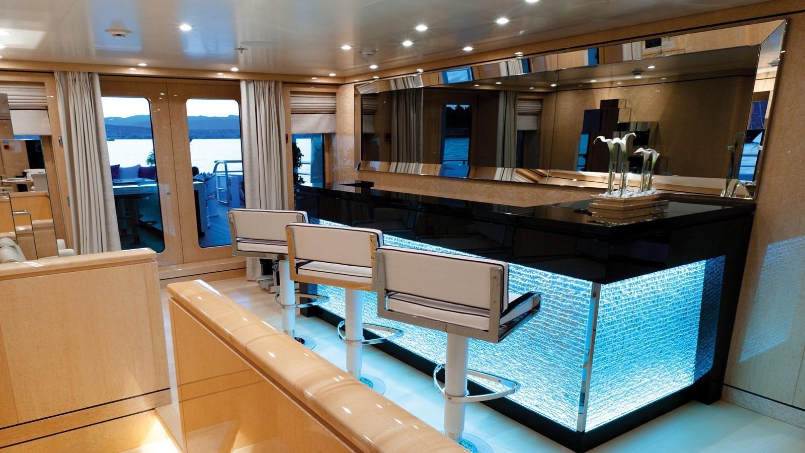 a room with a table and chairs aboard STEP ONE Yacht for Sale