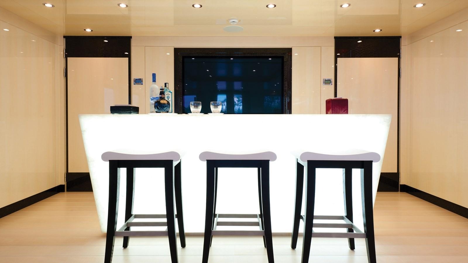 a table with stools and stools aboard STEP ONE Yacht for Sale