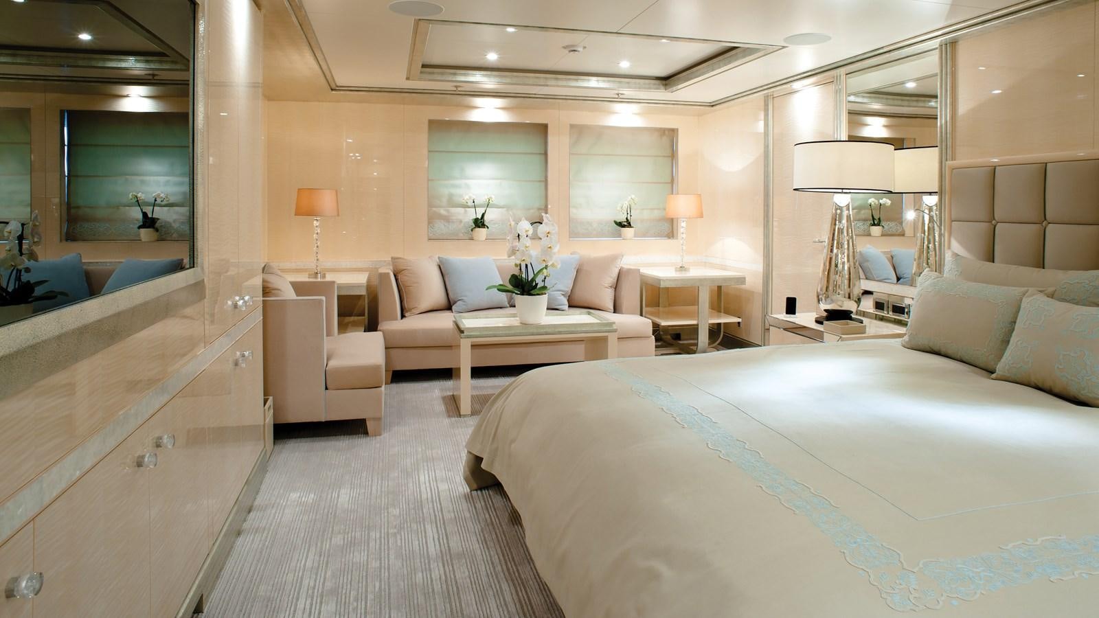 a hotel room with a bed and a desk aboard STEP ONE Yacht for Sale