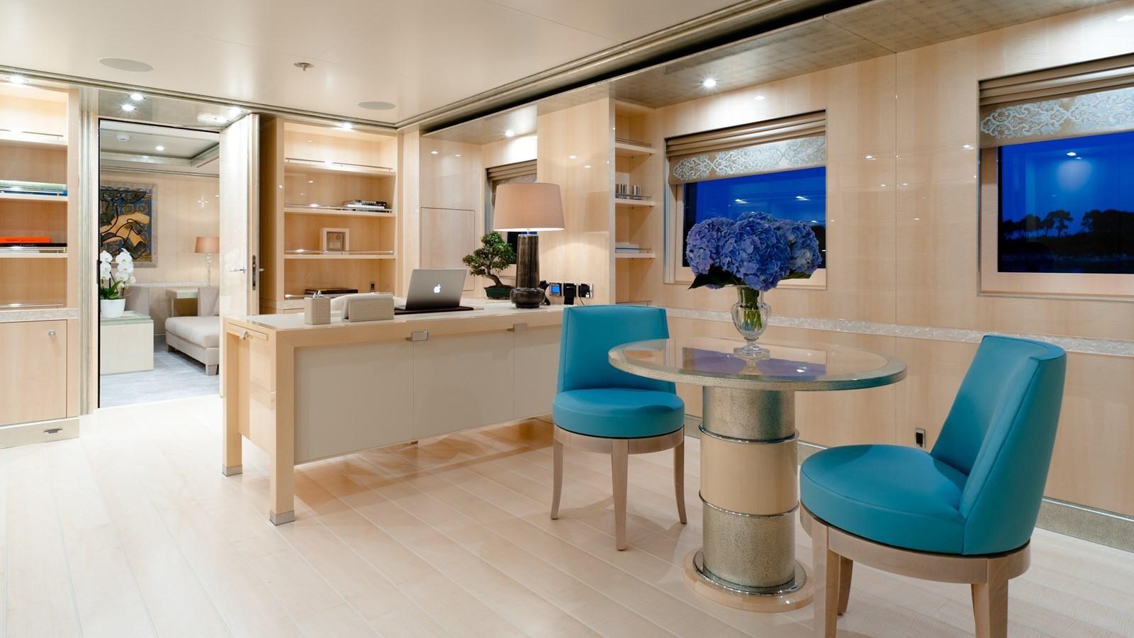 a room with a table and chairs aboard STEP ONE Yacht for Sale