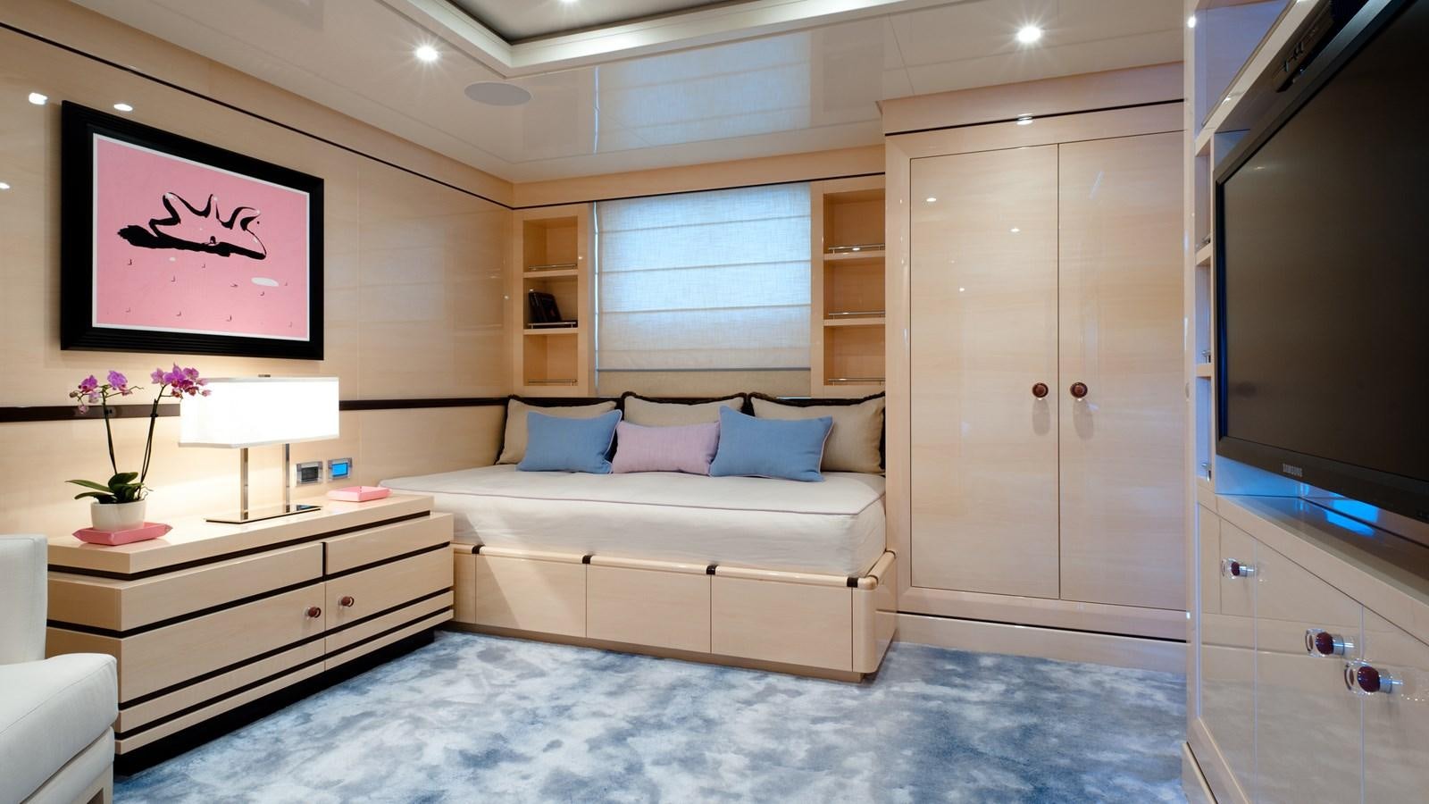 a room with a bed and a tv aboard STEP ONE Yacht for Sale