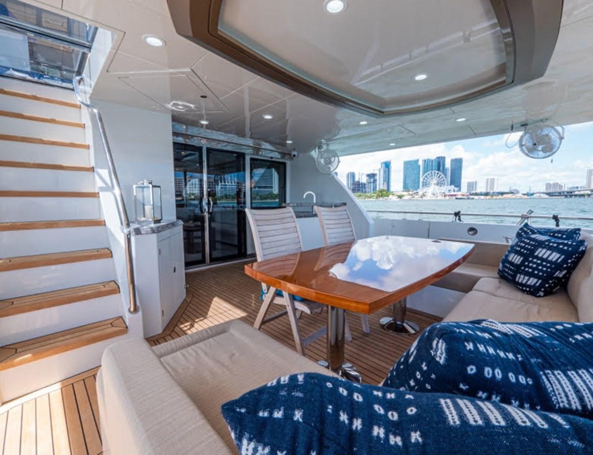 a living room with a staircase and a table aboard PHOENIX Yacht for Sale