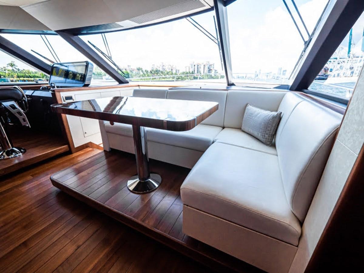 a couch and a table in a room with a window aboard PHOENIX Yacht for Sale