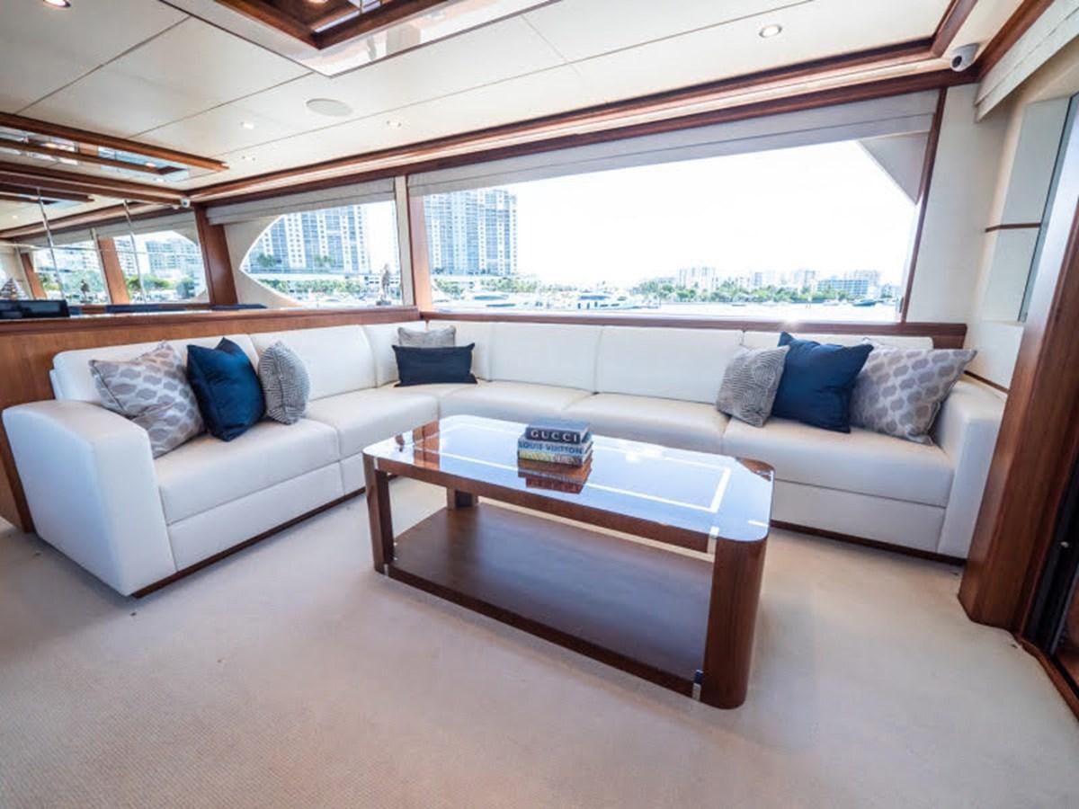 a living room with a couch and a coffee table aboard PHOENIX Yacht for Sale