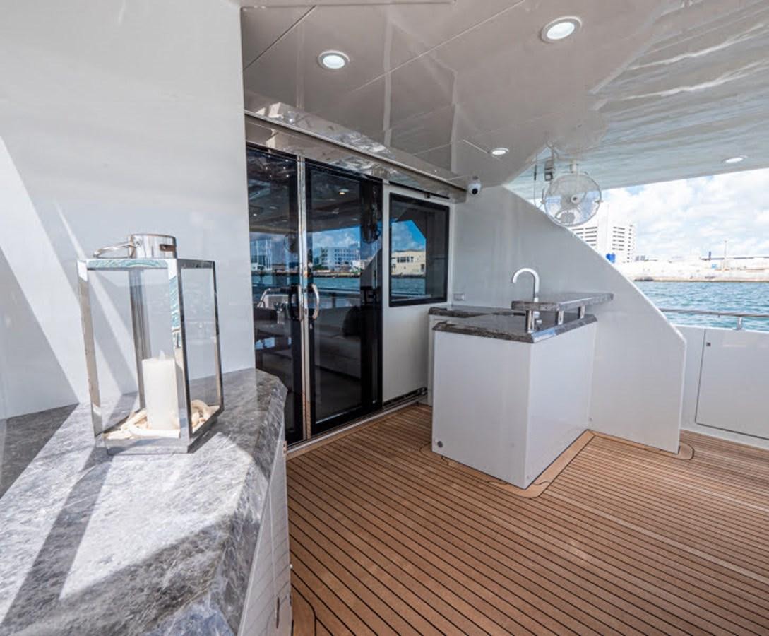 a modern looking kitchen with a large window and a large body of water aboard PHOENIX Yacht for Sale