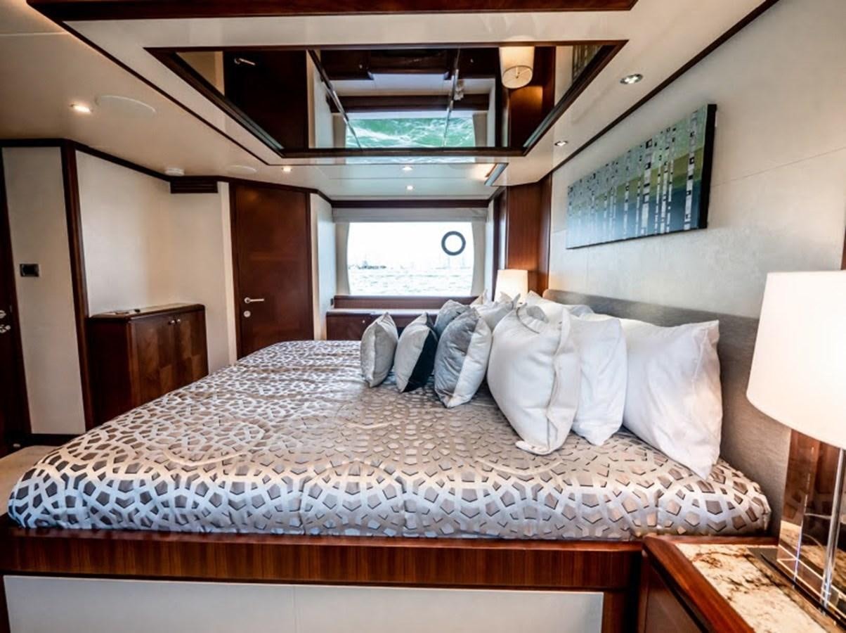 a bed with white pillows aboard PHOENIX Yacht for Sale