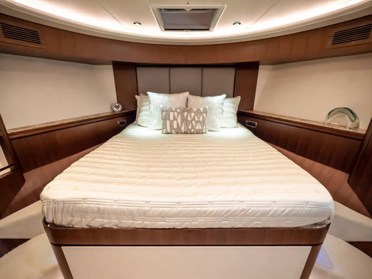 a bed with white sheets aboard PHOENIX Yacht for Sale