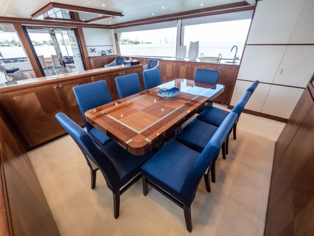 a table and chairs in a room aboard PHOENIX Yacht for Sale