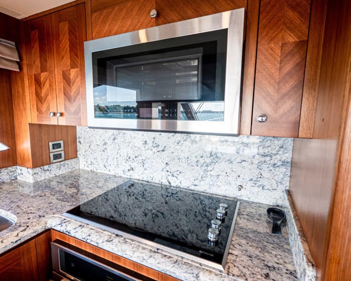a kitchen with a marble counter top aboard PHOENIX Yacht for Sale