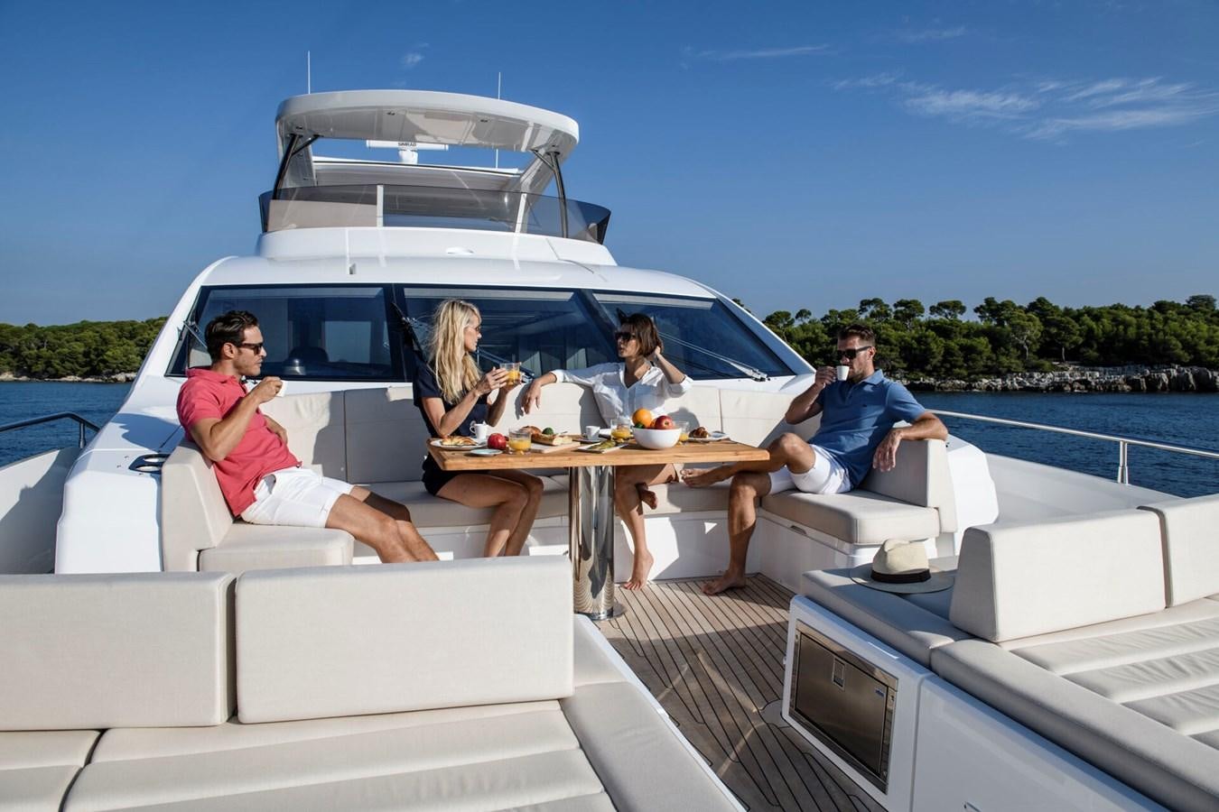 a group of people sitting at a table on a boat aboard SUNSEEKER 76 YACHT Yacht for Sale