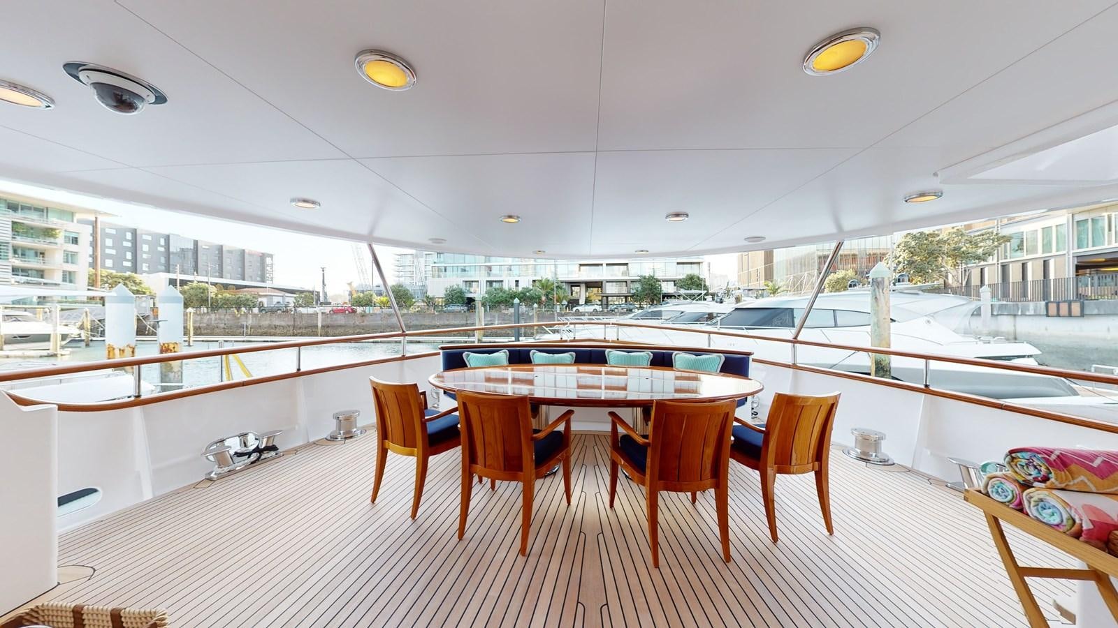 a large room with tables and chairs aboard ADYTUM Yacht for Sale