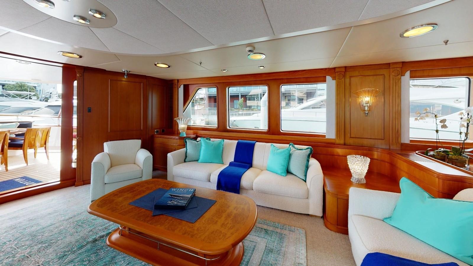 a living room with a couch and a table aboard ADYTUM Yacht for Sale
