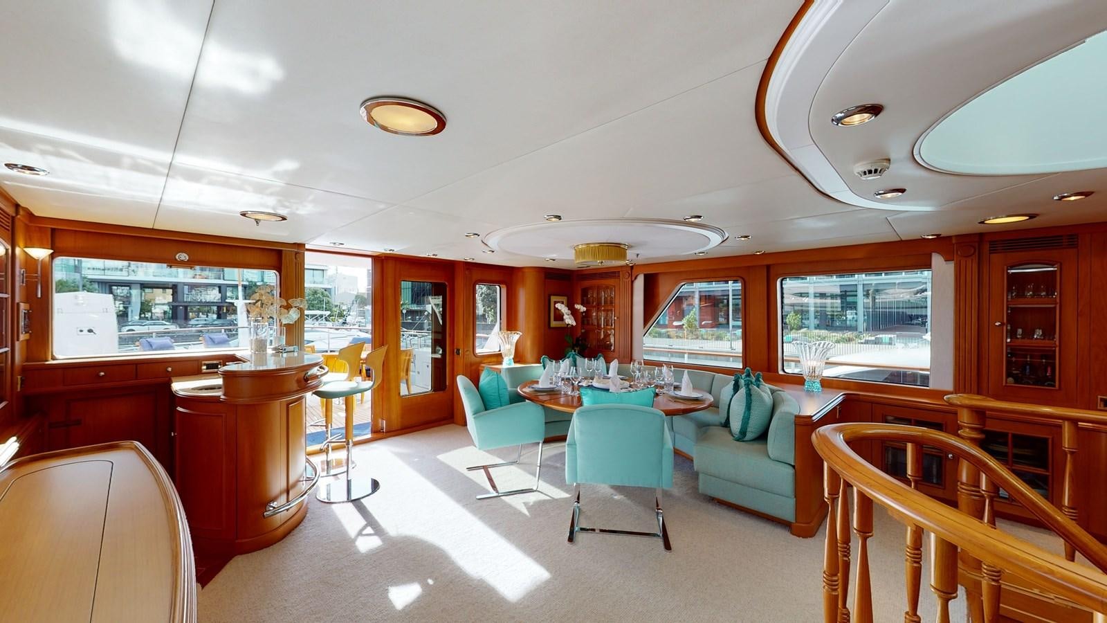 a room with tables and chairs aboard ADYTUM Yacht for Sale