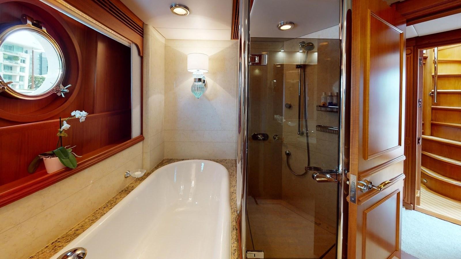 a bathroom with a tub and shower aboard ADYTUM Yacht for Sale