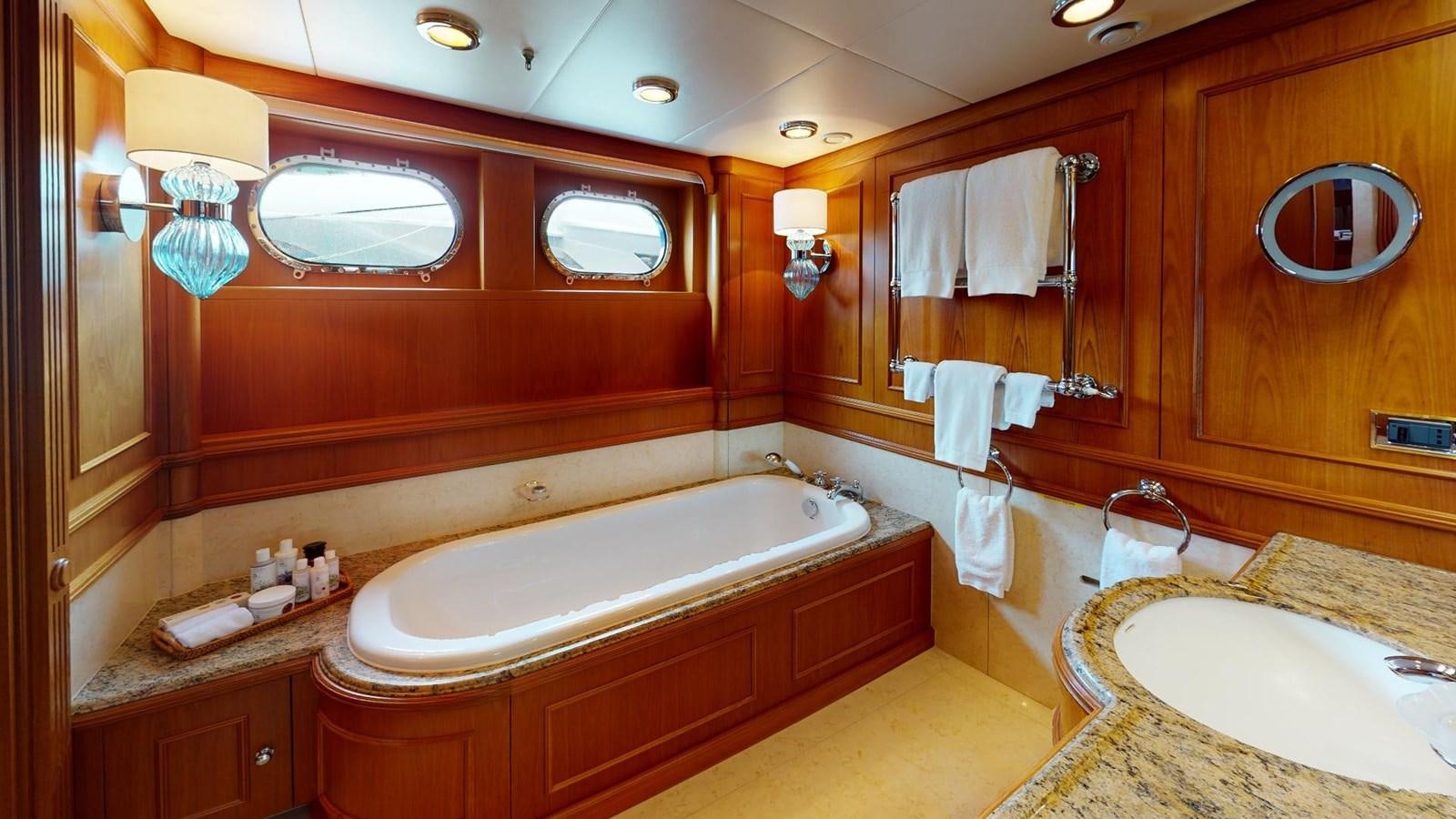 a bathroom with a bathtub and sink aboard ADYTUM Yacht for Sale